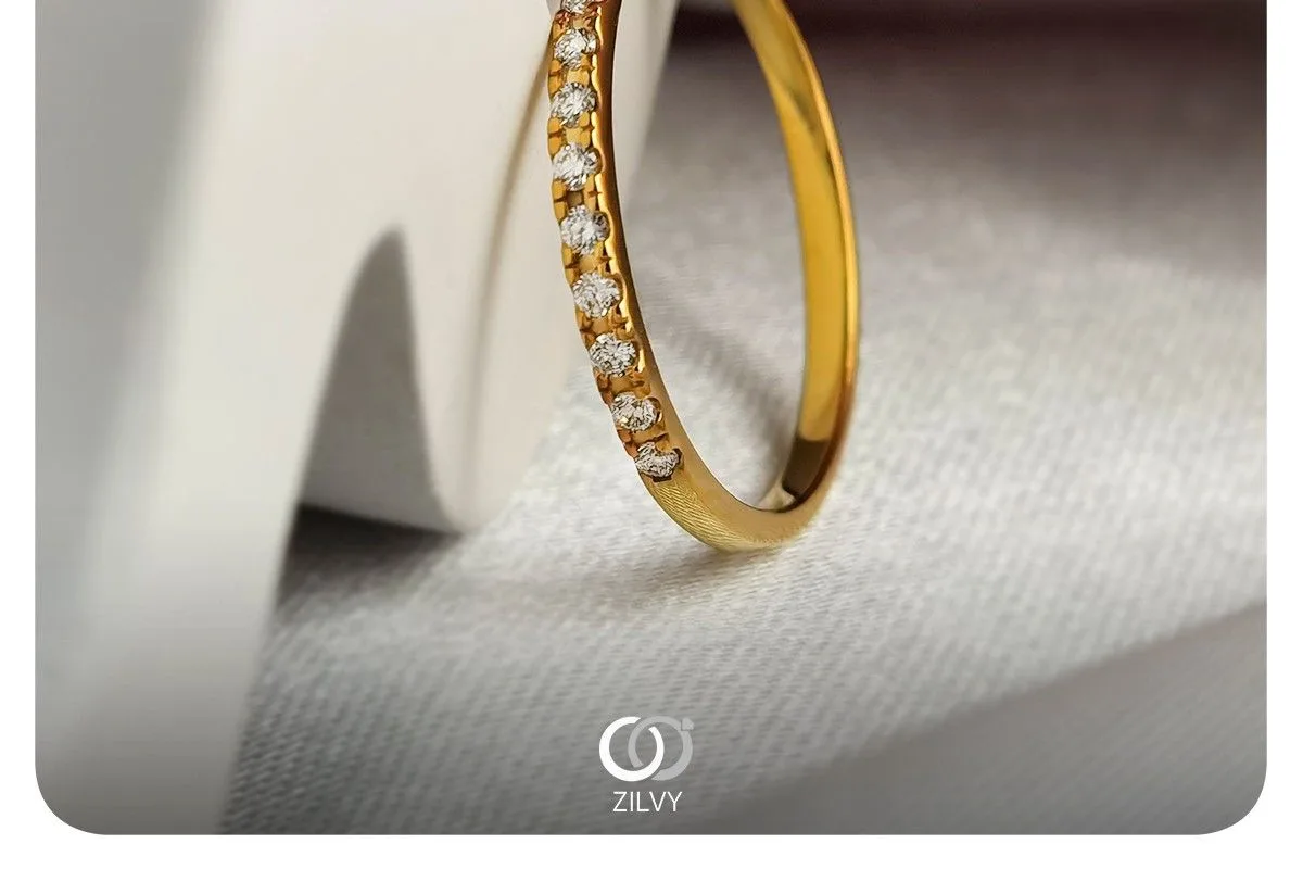 A ZILVY yellow-gold half-eternity diamond ring standing on white fabric