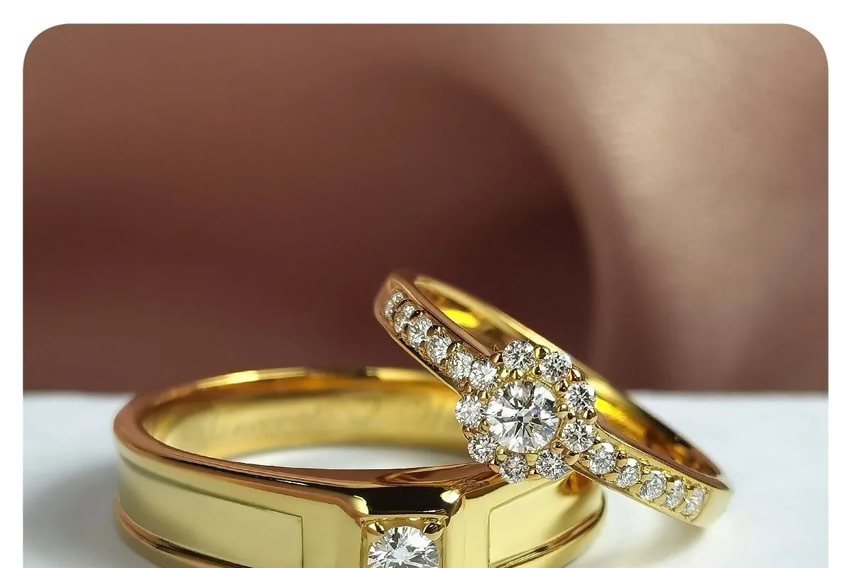 A ZILVY yellow-gold halo diamond ring paired with a men's band, ready for a proposal