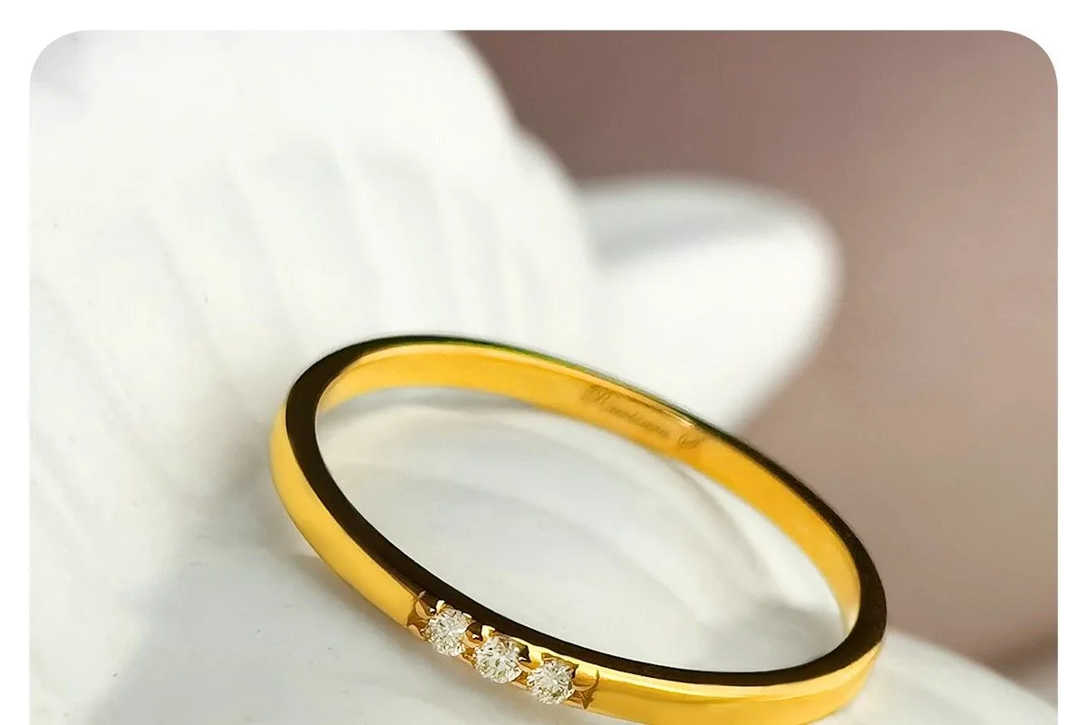 A ZILVY yellow-gold diamond ring resting against a white fabric glove